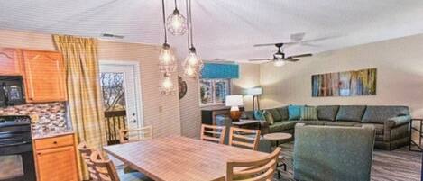 A compact living space with a dining area, kitchen, and seating area.
