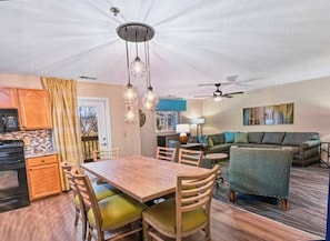A compact living space with a dining area, kitchen, and seating area.
