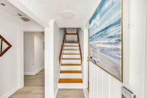 A staircase with white walls and wooden steps leading to an upper floor. - Delray Oasis - Heated Pool+Tiki Bar, 4 Kings (Delray Beach)