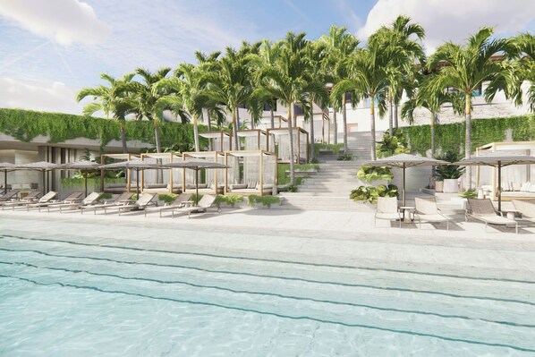 A resort with a pool, sun loungers, and palm trees. - KARV, a Luxury Collection Resort & Spa Jimbaran, Bali (Jimbaran)