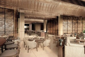A modern interior with a central bar area, multiple seating arrangements, and a textured ceiling. - KARV, a Luxury Collection Resort & Spa Jimbaran, Bali (Jimbaran)