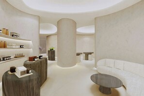 A modern interior with a central column, round tables, and a sofa. - KARV, a Luxury Collection Resort & Spa Jimbaran, Bali (Jimbaran)