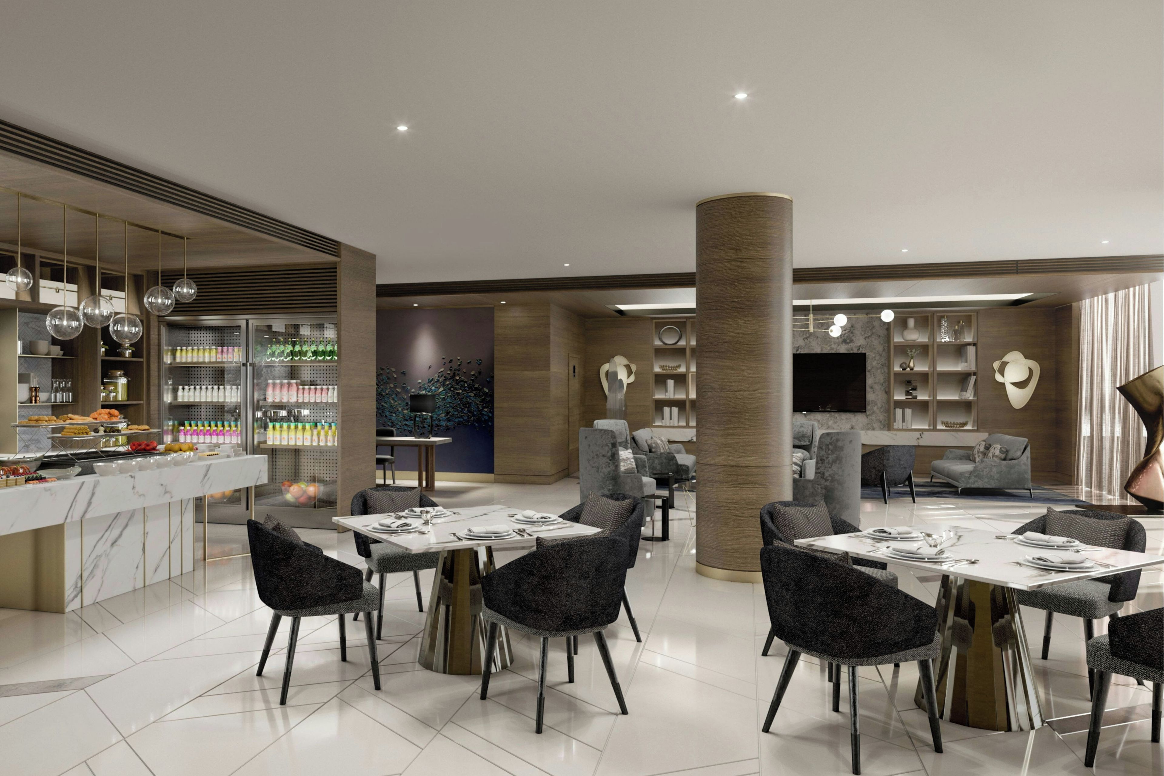 Un espace moderne dédié à la restauration dans un hôtel, comprenant un bar, des sièges et une grande colonne.