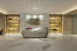A modern lobby with a central seating area, a patterned wall, and shelves with products. - Delta Hotels By Marriott Jeddah Al Salam (Jeddah)