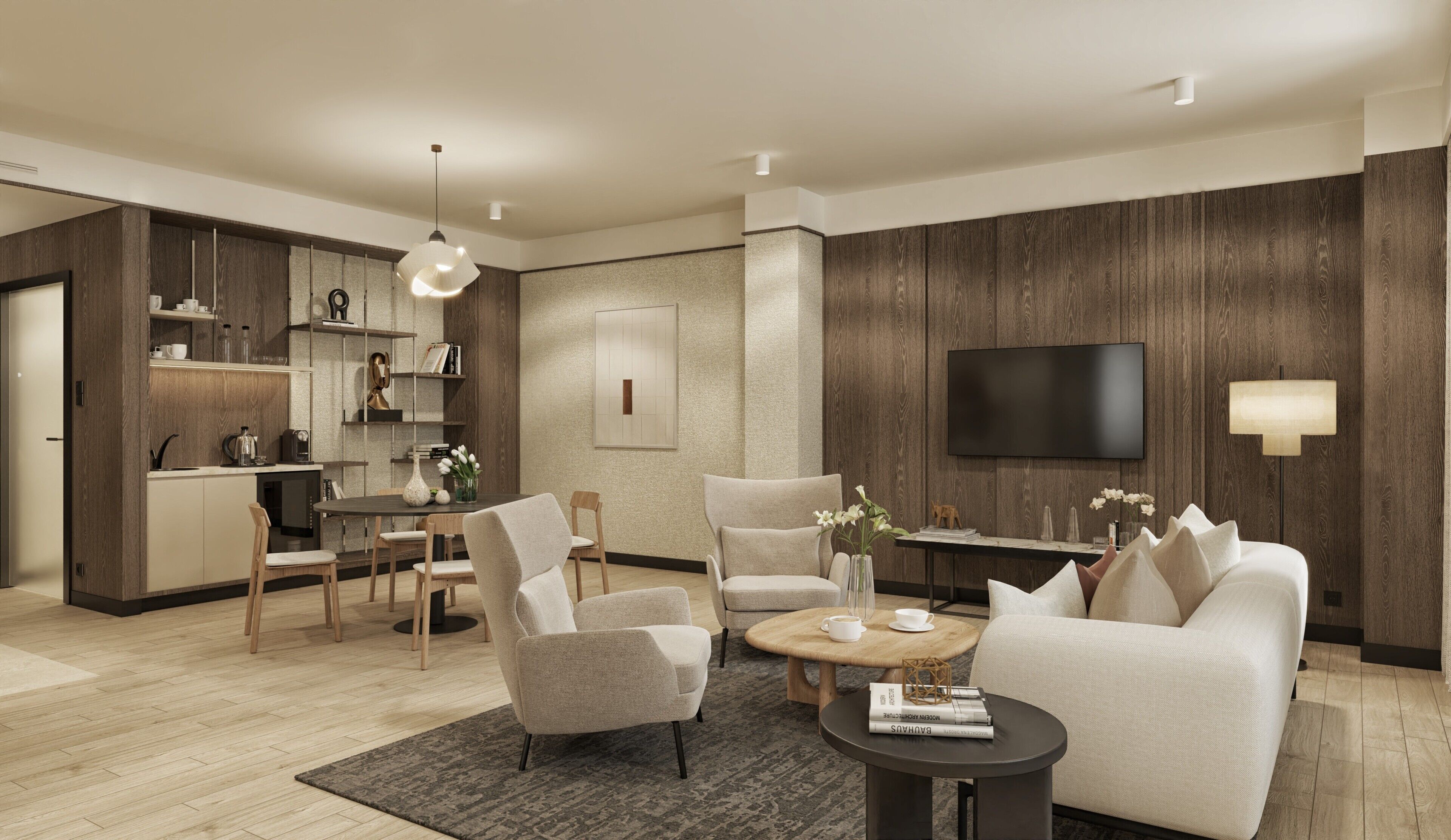 A modern living room with a sofa, chairs, a coffee table, and a TV mounted on the wall.