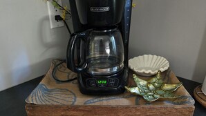 A coffee maker on a wooden tray with a placemat below stating 'coffee bar brewed coffee, fresh daily.' - Welcome to the Lake House.  A cozy 2 Bedroom Cottage just steps from the Beach. (Central Elgin)