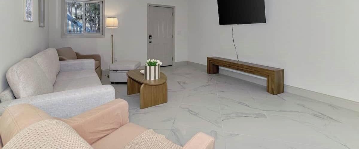 A living room with a sofa, a coffee table, and a bench.