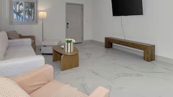 A living room with a sofa, a coffee table, and a bench.