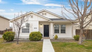 A single-story house with a front entrance, a mailbox, and a number 8234 on the side. - Boise Retreat, New, Hot Tub, Game Room (Ada County)
