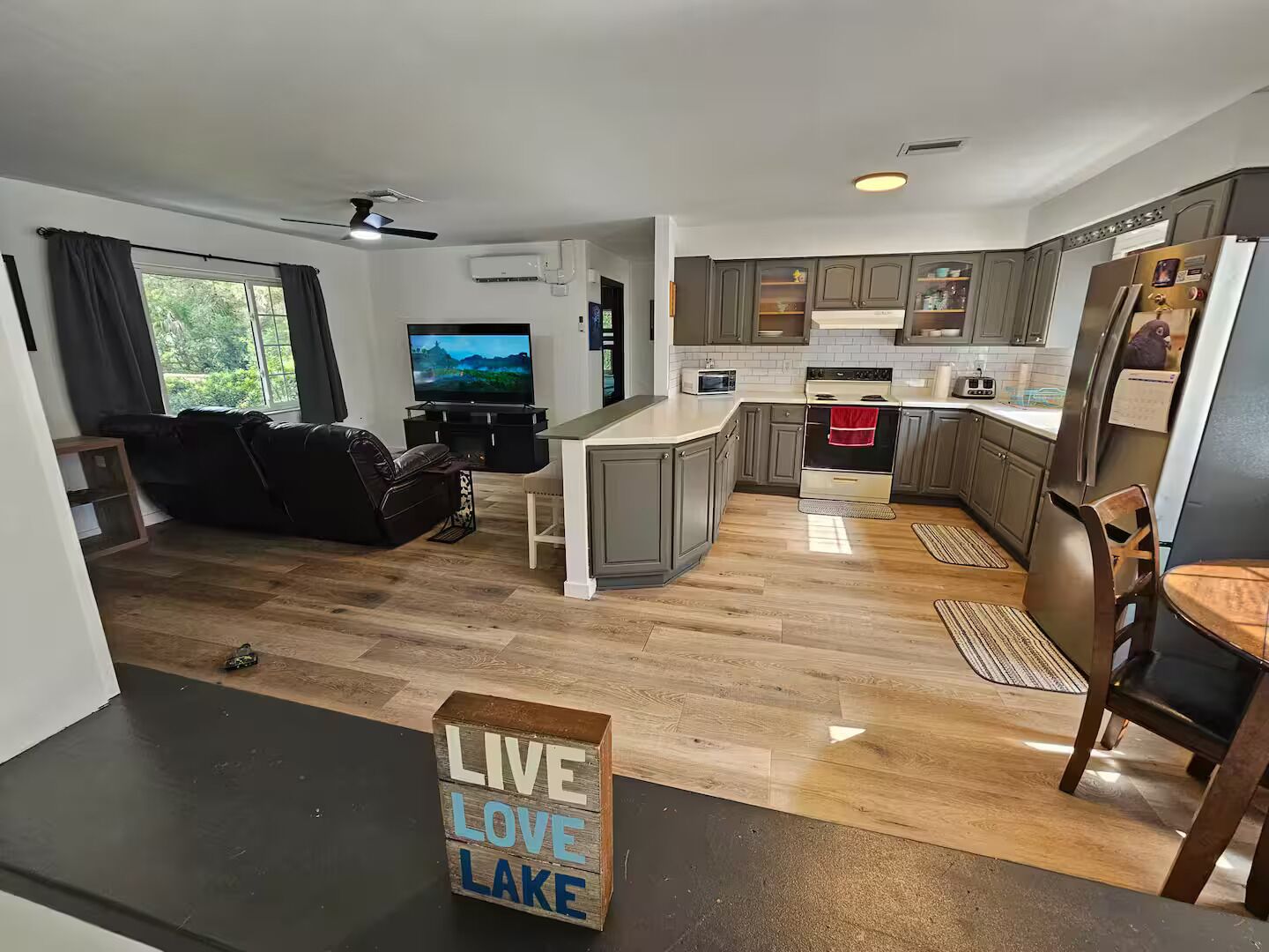 A modern apartment with a living room, kitchen, and dining area.