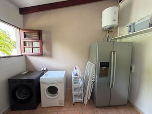 A compact laundry room with a washing machine, dryer, and a refrigerator. - Villa Horizon Bleu (SAINTE-LUCE)