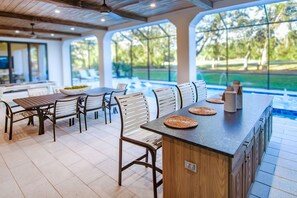 A spacious dining area with a long wooden bar and multiple seating options.