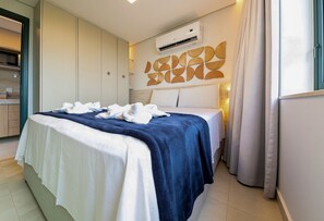 A hotel room with a bed, a wardrobe, an air conditioning unit, and a bathroom visible through an open door. - Vila Porto by Carpediem In Front of Porto de Galinhas Beach (Ipojuca)