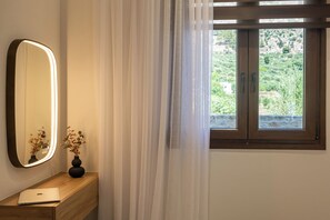 A room with a wooden desk, a laptop, a mirror, and a window with curtains. - Irisma Luxury Villa I | Private Pool near Heraklion, Crete (Archanes)