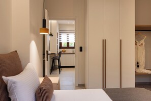 A hotel room with a bed, a desk, and a wardrobe. - Irisma Luxury Villa I | Private Pool near Heraklion, Crete (Archanes)