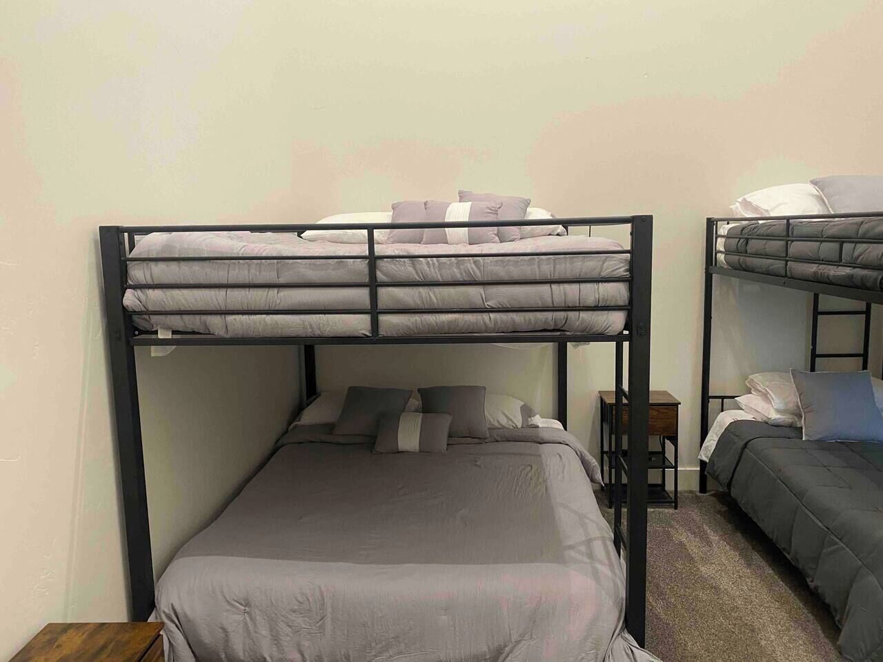 Quarto com uma cama de solteiro e duas beliches.