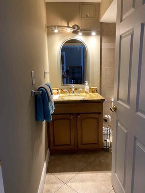 A bathroom with a vanity, mirror, and towel rack. - 2BR/2BA Beach Condo- Full Kitchen-sleeps 4 (Daytona Beach)