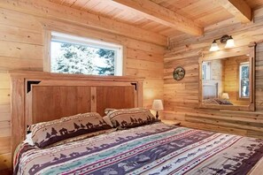 A wooden cabin interior with a bed, a window, and a mirror. - Moose Cabin /Hot Tub - A Bridge to Mountain Bliss (South Fork)