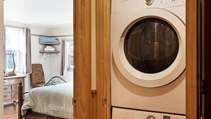A room with a bed, a wooden wardrobe, and a washing machine. - Gressoney Family Retreat | Pond & Hot Tub (South Fork)