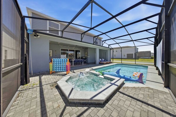 A covered outdoor area with a swimming pool, hot tub, and seating area. - Hogwarts & Star Wars Themed Rooms, Pool, Game Room (Davenport)