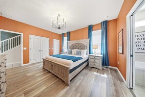 A bedroom with a bed, nightstands, a chandelier, and a staircase. - Hogwarts & Star Wars Themed Rooms, Pool, Game Room (Davenport)