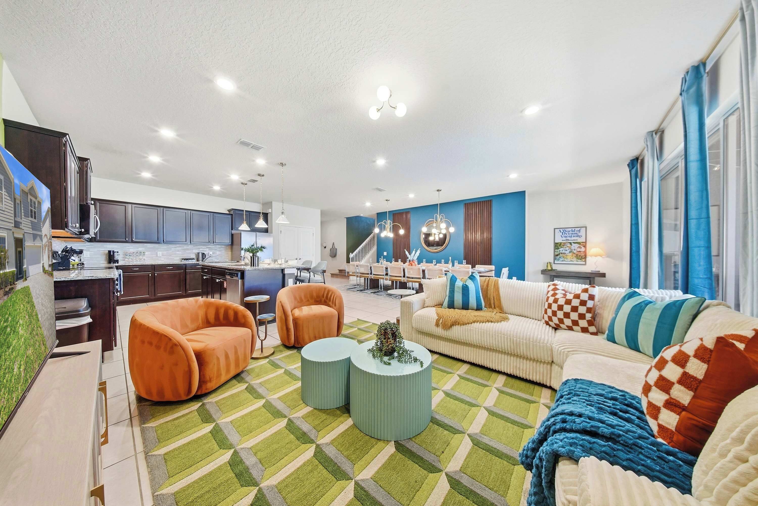 A modern living room with a sofa, armchairs, and a coffee table.