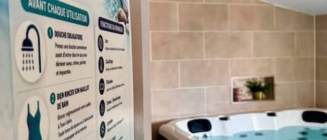 A spa area with a hot tub and informational signage detailing usage instructions.
