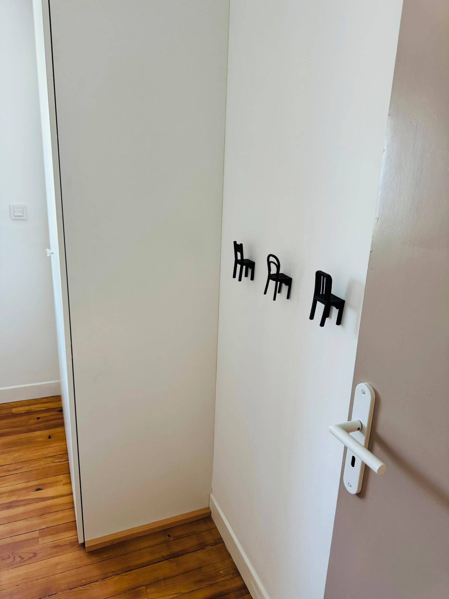 A white door with a white handle and a small white switch.