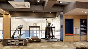 Une salle de sport équipée de machines de cardio, de poids libres et d’un tapis de course.