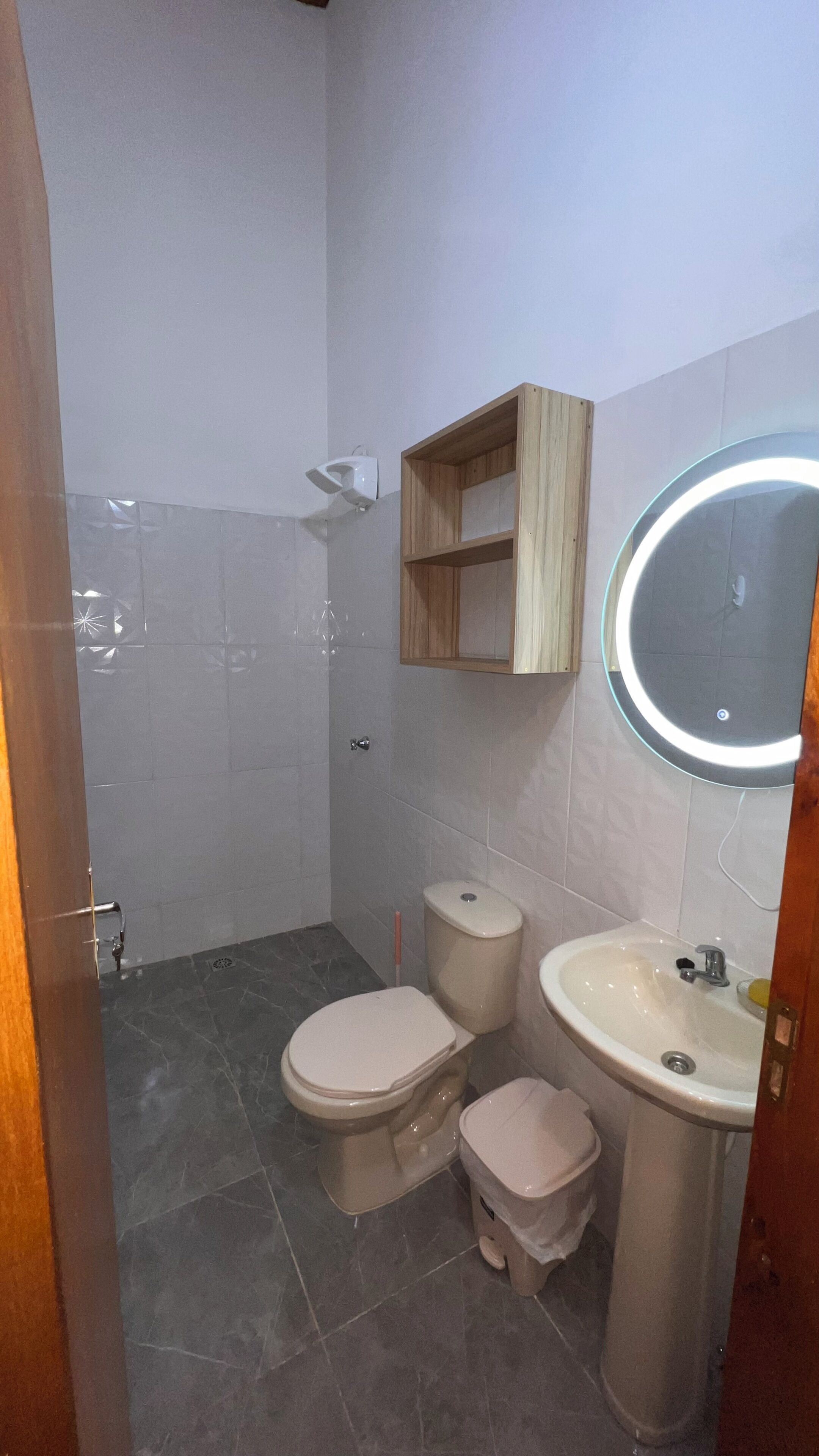 A bathroom with a toilet, bidet, and sink.