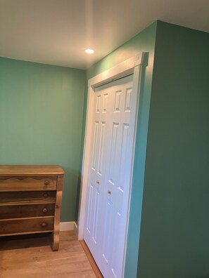 A room with teal walls, a wooden dresser, and a white door. - Georgetown Ranch Rental - Great For Families & Golfers! (Georgetown)