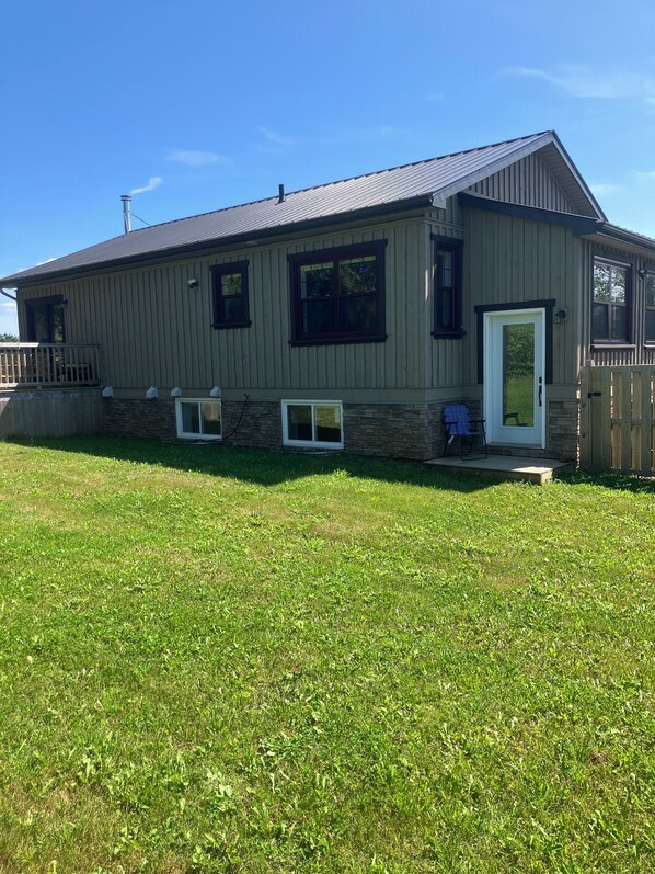 A single-story house with a front porch, a stone foundation, and a metal roof. - Georgetown Ranch Rental - Great For Families & Golfers! (Georgetown)