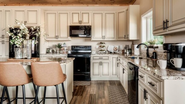 A kitchen with wooden cabinets, a microwave, a stove, and a coffee maker. - Private Pool • Smoky Mountain Views • Game Room (Gatlinburg)