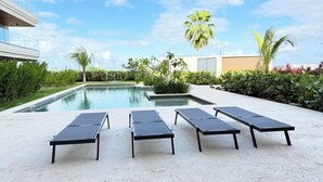A modern outdoor pool area with lounge chairs and a clear sky. - Vermare Bliss 2 Br private pool BBQ Cap Cana (Punta Cana)