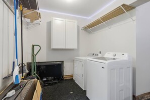 A laundry room with a washing machine, dryer, and a cabinet. - 4Br Lux Stay w/Pool & Game Room - Sleeps 10 (Concord)