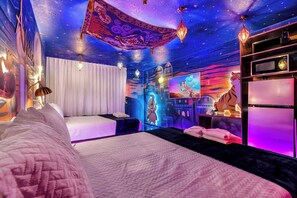 A room with a bed, a TV, and a refrigerator. - Aladdin inspired Studio Near Disney (Kissimmee)
