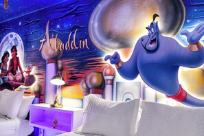 A themed room with a large mural of Aladdin, a night sky, and a crescent moon. - Aladdin inspired Studio Near Disney (Kissimmee)