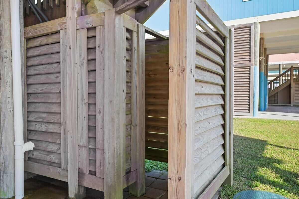 A wooden structure with a slatted design, possibly a deck or patio area.