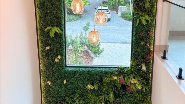 A room with a large window, a hanging light fixture, and a green wall. - Tropical, Large Modern Keys, New Island Mansion with a pool & 2 boat docks (Key Largo)