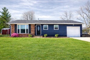 A single-story house with a garage, a front porch, and a well-maintained lawn.