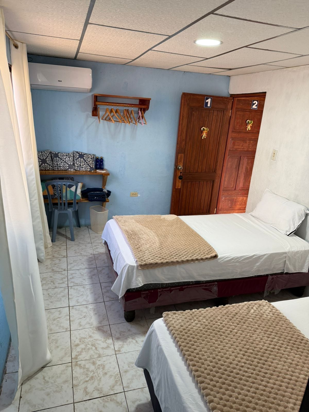 A room with a bed, a desk, and a wardrobe.