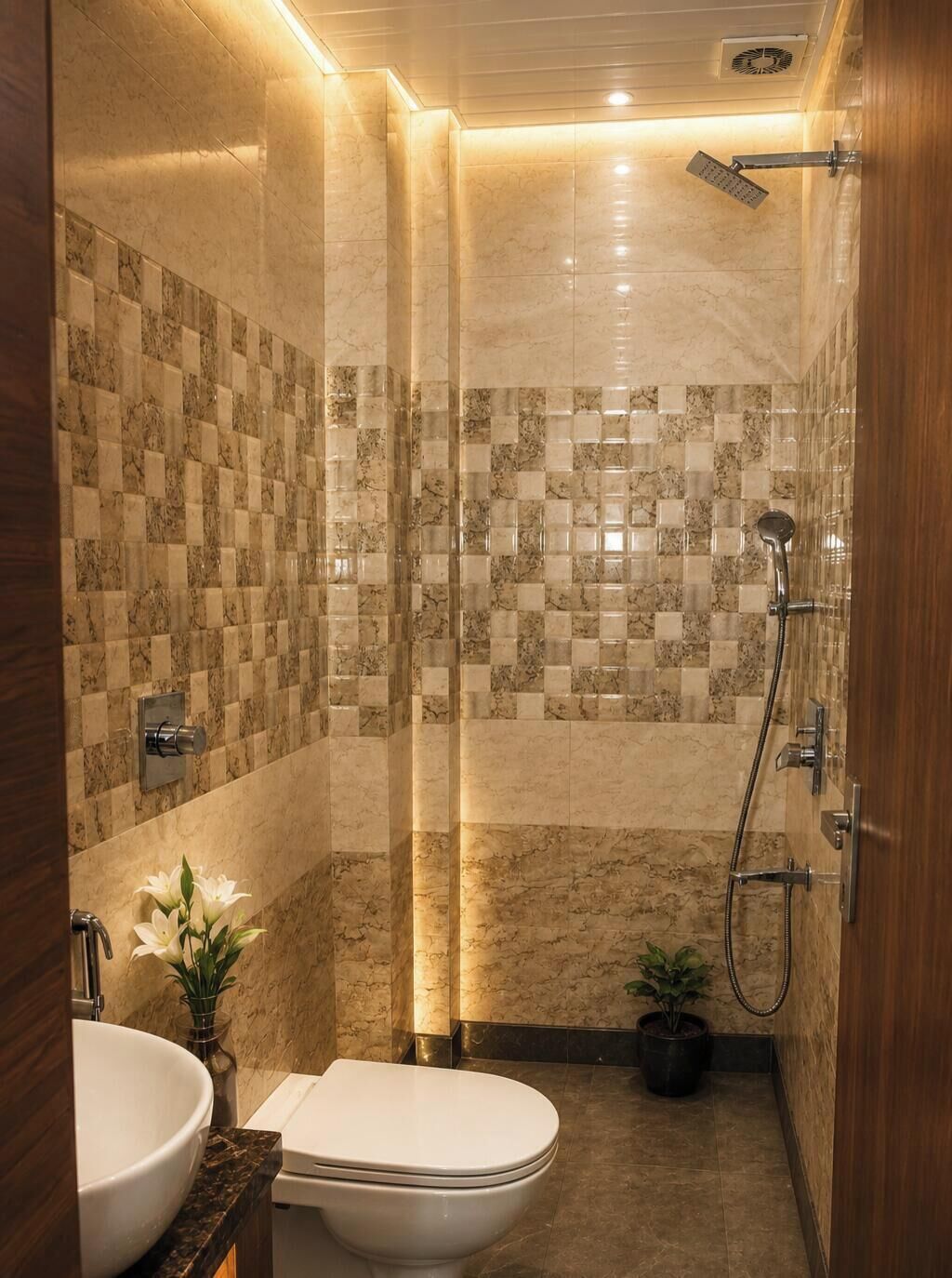 A modern bathroom with a marble tiled shower wall, a toilet, a sink, and a potted plant.