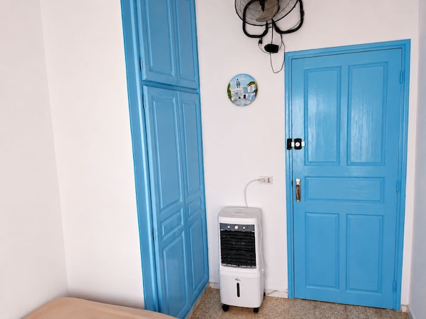 A room with a blue door, a white air conditioner, and a wall-mounted fan. - Hotel Youssef Sousse Medina (Sousse)