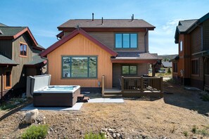 A two-story wooden house with a hot tub and a deck. - Coyote Creek 1602 I Private Hot Tub I Great Views I Bunk Room I Discounted Attractions (Tabernash)