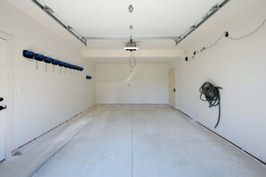 A spacious, empty room with a high ceiling, a door on the left, and a wall-mounted cable on the right. - Milky Way Mountain Chalet I Private Hot Tub I Great Views I Bunk Room I Discounted Attractions (Fraser)