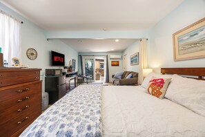A hotel room with a bed, a desk with a computer, a television, and a view of the outside. - 1 Block to Beach | Newport Beach Studio w/ Modern Bath, Courtyard & Bikes (Newport Beach)
