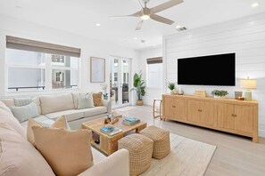 A modern living room with a sofa, coffee table, and TV.