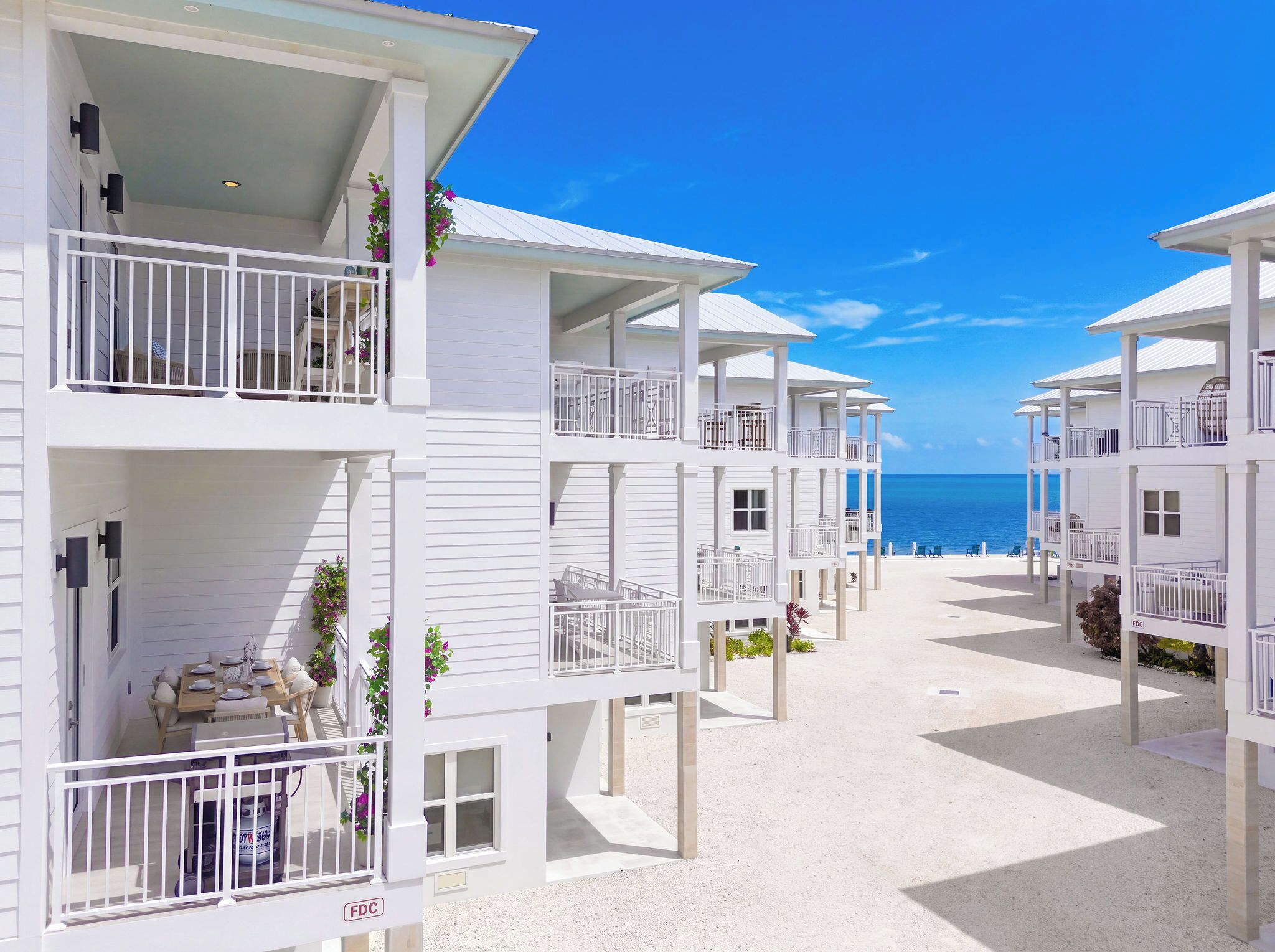 Un hôtel situé en bord de mer, doté de nombreux balcons, d’un espace extérieur aménagé et offrant une vue dégagée sur l’océan.