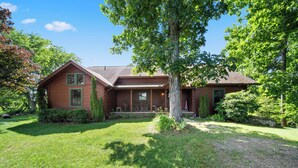 A two-story house with a front porch, a large tree in front, and a well-maintained lawn. - Spacious Mountain Getaway Minutes from Boone (Boone)