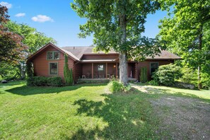 A two-story house with a front porch, a large tree in front, and a well-maintained lawn. - Spacious Mountain Getaway Minutes from Boone (Boone)